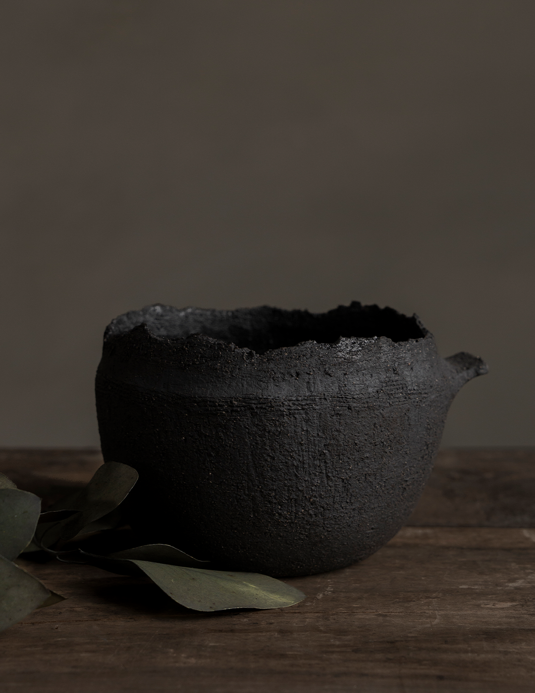 Black Vessel With Handle